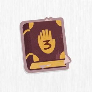 May include: A brown leather-bound journal with a gold hand and the number "3" on the cover. The journal has a gold clasp and a yellowed page sticking out.