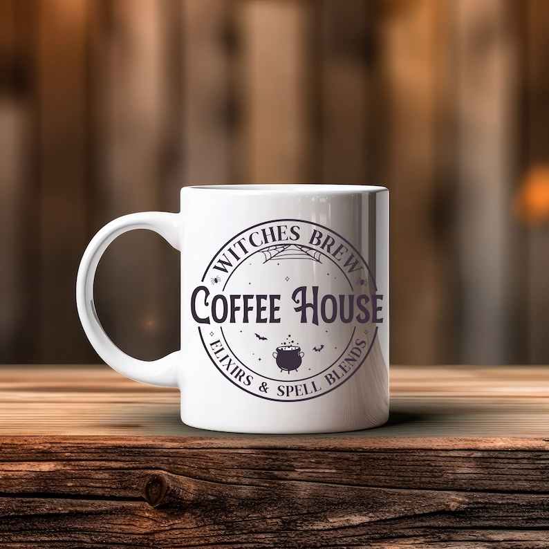 May include: White ceramic coffee mug with a black and white graphic design that says "Witches Brew Coffee House - Elixirs & Spell Blends".
