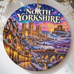 May include: A round ceramic ornament featuring a vibrant winter landscape of North Yorkshire, including a cathedral, a steam train on a stone bridge, and snow-covered buildings decorated with Christmas wreaths under a starry sky.