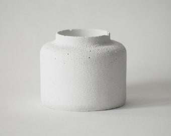 Candle holder bottle in sandblasted white concrete