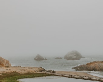 May include: A scenic landscape photograph of a coastal area on a foggy day. The image features a body of water, rocks, and a building on a cliff. The text "SHUTTER PINE Photography" is at the bottom.