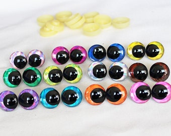 May include: Assortment of 12 pairs of colorful plastic safety eyes for crafts. Each eye is approximately 1 inch in diameter with a black pupil.