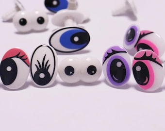 May include: A collection of plastic toy eyes in various colors, including blue, pink, purple, and red. The eyes have a white background and black pupils. Some eyes are double-eyed, and some have a stem for attachment.