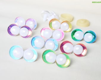 May include: Assortment of iridescent plastic safety eyes in various colors, including pink, blue, green, and white. The eyes are suitable for craft projects and plush toy making.