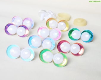 May include: Assortment of iridescent plastic safety eyes in various colors, including blue, green, pink, and purple. The eyes are ideal for craft projects and plush toy making.