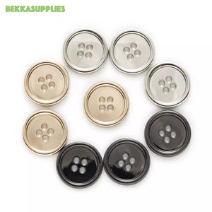 May include: Assortment of eight round metal buttons with five holes each. The buttons are in four different colors: silver, gold, black, and a light gold.