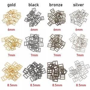 Op de afbeelding: Assortiment van metalen schuifgespen in goud, zwart, brons en zilver. De gespen zijn verkrijgbaar in drie maten: 6 mm, 7 mm en 8,5 mm.