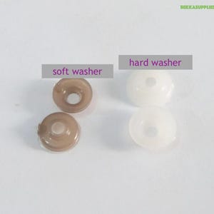 May include: Two soft brown rubber washers and two hard white plastic washers. The washers are used for sewing projects.