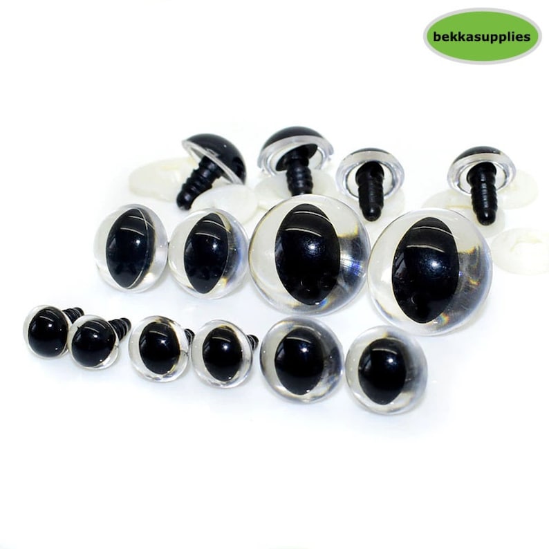May include: Assortment of clear plastic safety eyes with black pupils, in various sizes, with some eyes having plastic washers and screw backs.