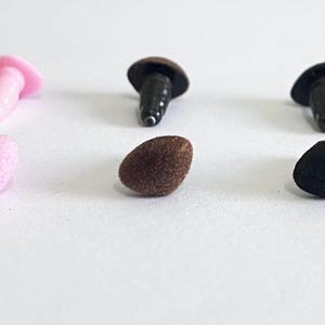 May include: Three pairs of plastic safety eyes for crafts. The eyes are available in pink, brown, and black. Each eye has a plastic post for attaching to fabric or other materials.