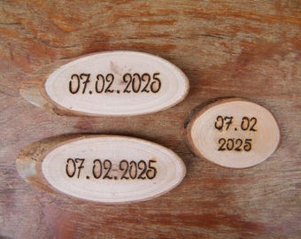 May include: Three wooden oval-shaped slices with the date "07.02.2025" burned into the surface. The wood has a natural grain and a light brown color. One smaller, round slice also displays the same date.