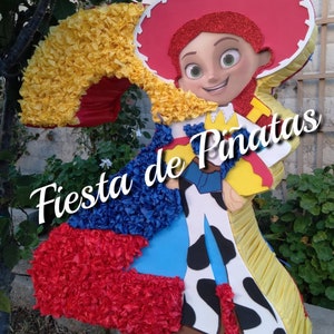 May include: A red, yellow, and blue pinata shaped like the character Jessie from Toy Story. The pinata is decorated with tissue paper and has the text "Fiesta de Pi&ntilde;atas" on it.