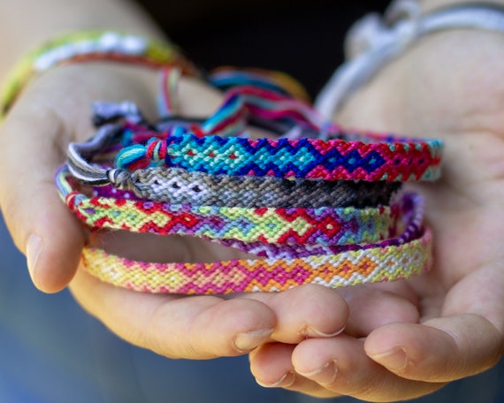Premium Photo | Tied woven diy friendship bracelet with bright colorful  pattern