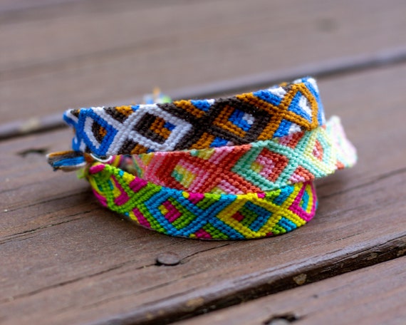 Woven DIY friendship bracelets handmade of embroidery floss with knots in  green colors Stock Photo - Alamy