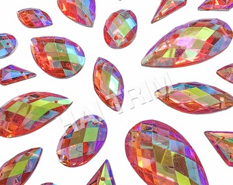 May include: A collection of iridescent, faceted rhinestones in various shapes, including teardrops, ovals, and marquise. The rhinestones have a vibrant, multi-colored sheen, reflecting hues of red, orange, yellow, and green. They are scattered against a white background.