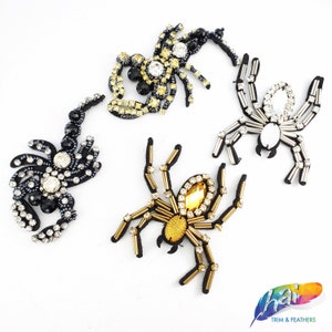 May include: Four beaded spider and scorpion appliques. The appliques are black, gold, and silver with rhinestones. The appliques are perfect for adding a touch of Halloween or gothic style to your crafts.