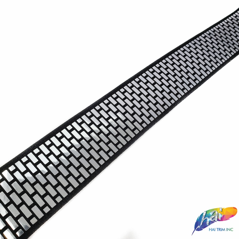 May include: Black trim with a silver reflective brick pattern.
