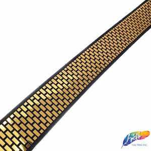 May include: Gold trim with a black background. The trim has a repeating pattern of small gold rectangles.