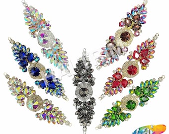 May include: Assortment of seven rhinestone embellishments in various colors, including iridescent, blue, red, green, brown, and gray. Each embellishment features a large central rhinestone surrounded by smaller rhinestones in a floral design.