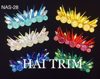 May include: Six rows of colorful rhinestones with spikes, each row featuring a different color: blue, white, yellow, red, purple, and green. The text "HAITRIM" is visible in the center of the image.