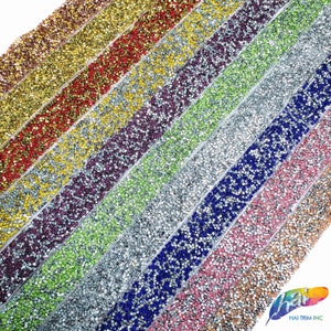 May include: Assortment of colorful rhinestone trim, featuring various colors like gold, red, purple, green, silver, blue, pink, and champagne. Each trim is made of small, sparkling rhinestones.