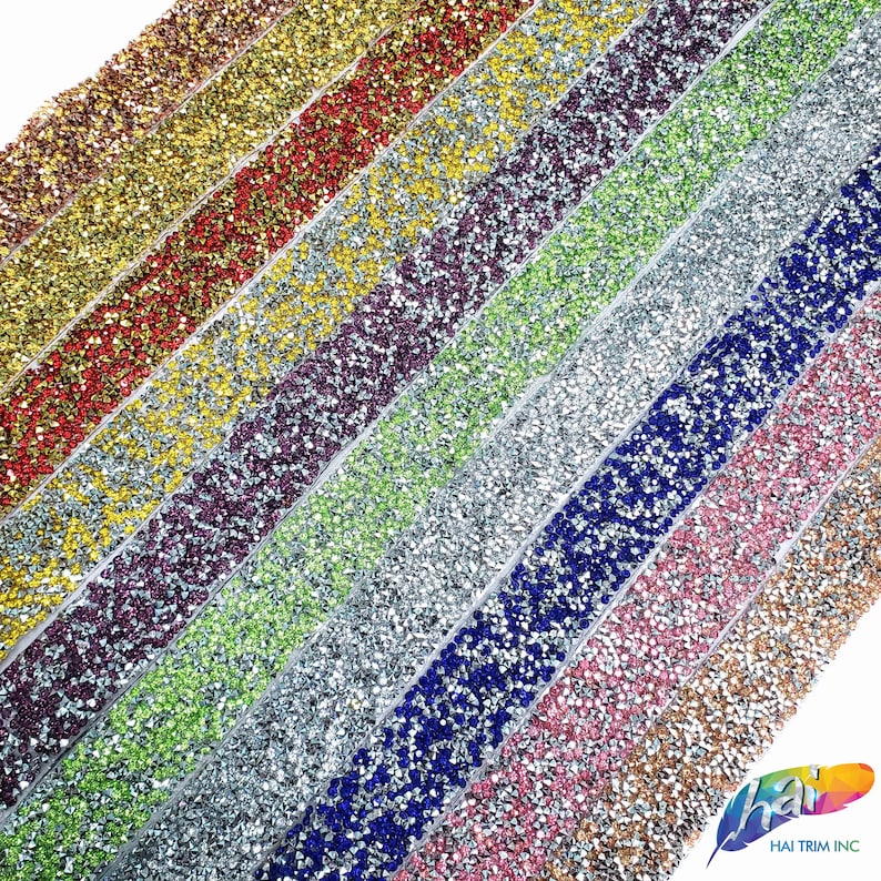 May include: Assortment of colorful rhinestone trim, featuring various colors like gold, red, purple, green, silver, blue, pink, and champagne. Each trim is made of small, sparkling rhinestones.