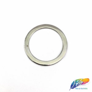 May include: A silver metal ring with a smooth, polished finish. The ring is circular and has a wide, flat band.