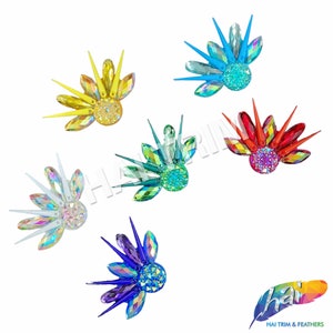 May include: Six different colored crystal embellishments with a fan-like shape. Each embellishment has a central round crystal surrounded by smaller crystals and spikes.
