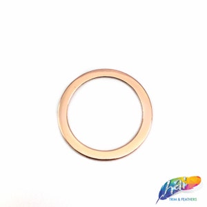 May include: A rose gold metal ring with a smooth, polished finish. The ring is about 1 inch in diameter.
