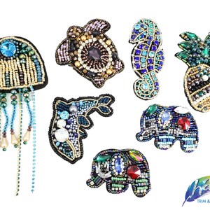 May include: Assortment of colorful beaded iron-on patches featuring a variety of animal and nature designs, including a jellyfish, turtle, seahorse, pineapple, elephant, and fish. The patches are all made with colorful beads and sequins.