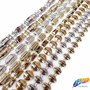 May include: Assortment of gold and silver metal chain trim with different patterns and designs. The trim features oval, round, and rectangular shapes.