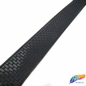 May include: Black elastic band with a repeating pattern of small, raised squares. The band is approximately 1 inch wide.