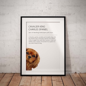 May include: A framed print with a watercolor illustration of a Cavalier King Charles Spaniel dog. The print includes the dog's breed name, pronunciation, and a description of the breed's personality.