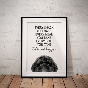 May include: A black and white printable art print with a black dog peeking out from the bottom of the frame. The text reads "Every snack you make, every meal you bake, every bite you take, I'll be watching you."