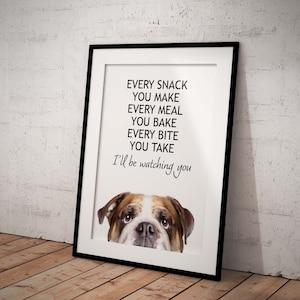 May include: A white framed print with a black and white illustration of a bulldog peeking over the top. The text reads "Every snack you make, every meal you bake, every bite you take, I'll be watching you."