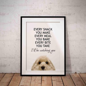May include: Framed print with a black border. The print features a dog and the text "EVERY SNACK YOU MAKE EVERY MEAL YOU BAKE EVERY BITE YOU TAKE I'll be watching you" in black font.