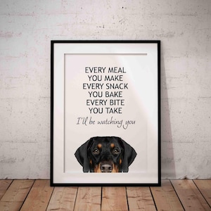May include: Framed print with a black border. The text reads "EVERY MEAL YOU MAKE EVERY SNACK YOU BAKE EVERY BITE YOU TAKE I'll be watching you." A dog's face is at the bottom of the print.
