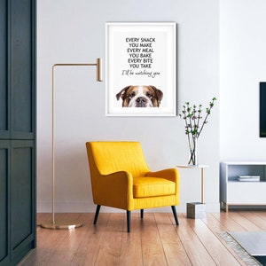May include: A white framed print with a bulldog's face peeking out from the bottom. The text reads "Every snack you make, every meal you bake, every bite you take, I'll be watching you."