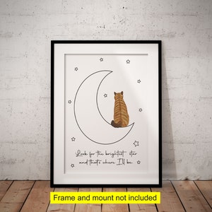 May include: A white crescent moon with a black outline and a small orange tabby cat sitting on the moon. The moon is surrounded by small black stars. The text "Look for the brightest star and that's where I'll be." is written below the moon.