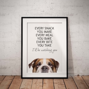 May include: A white framed print with a black and white bulldog peeking out from the bottom. The text reads "Every snack you make, every meal you bake, every bite you take, I'll be watching you."