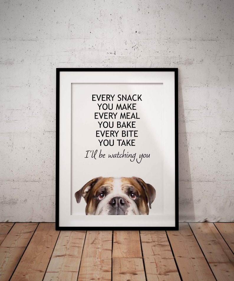May include: A white framed print with a black and white bulldog peeking out from the bottom. The text reads "Every snack you make, every meal you bake, every bite you take, I'll be watching you."