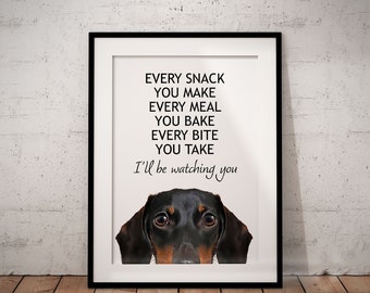 May include: Framed print featuring a dachshund dog with a black and brown coat. The print includes the text "Every snack you make, every meal you bake, every bite you take, I'll be watching you" in black font.