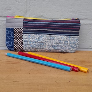 May include: A trio of ceramic mugs with a speckled, matte finish in cream, light grey, and dark grey. Each mug features a simple, minimalist design, ideal for tea or coffee.