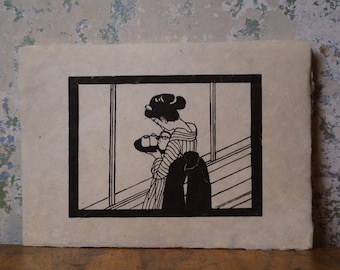 May include: Black and white woodcut print of a woman in a striped dress carrying a tray with two cups. The print is framed in a black frame and is on a beige background.