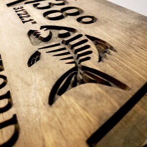 May include: A wooden sign with the text "268" and "FRANKFORD" carved into the surface. A fish silhouette is also carved into the wood.