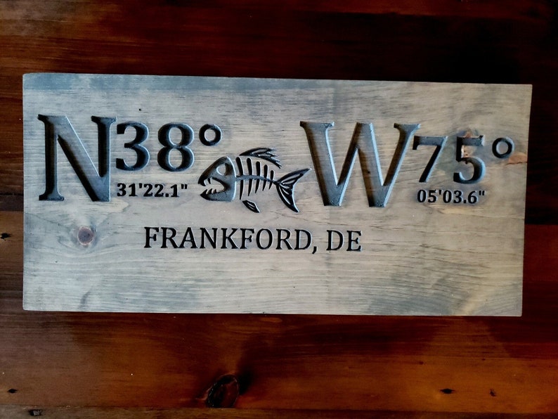 May include: A wooden sign with the coordinates N38&deg;31'22.1" W75&deg;05'03.6" and the text "Frankford, DE".