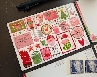 May include: A collection of Christmas-themed stickers and postcards. The stickers feature festive illustrations of Santa, gifts, stockings, and candy canes in red, green, and pink. Two Eleanor Roosevelt stamps are also visible.