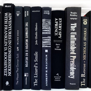 May include: A collection of ten black hardcover books with white lettering on the spines. The titles include "Adventures in Conservation with Franklin D. Roosevelt", "The Ultimate Weapon is No Weapon", "The Lizard's Smile", "Final Harvest", "Every Spy a Prince", "The Unfinished Presidency", "The Rescue", and "Blood and Honor".