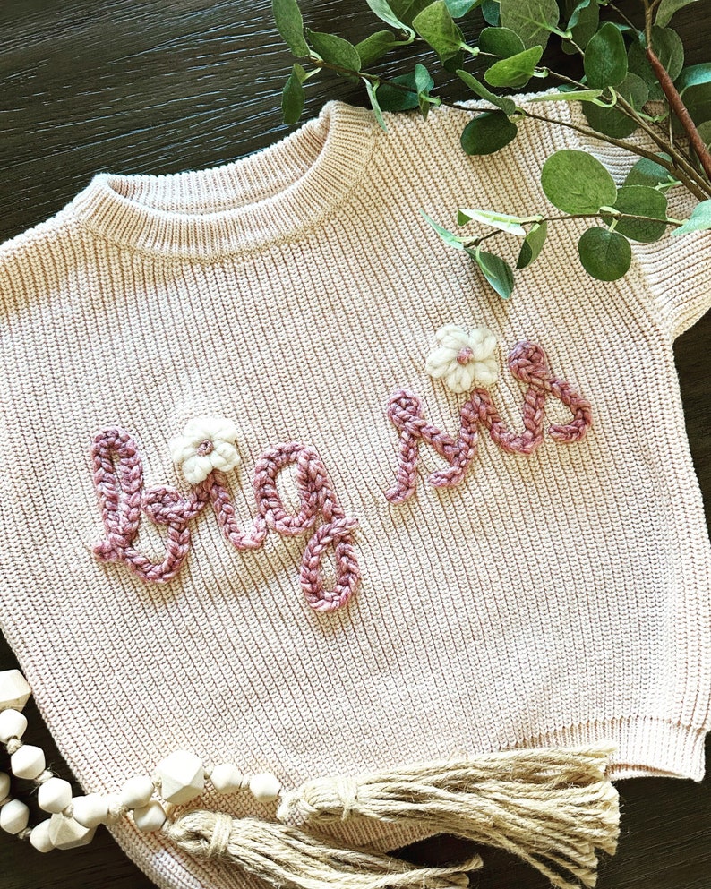 The classic, an ivory sweater, with dream yarn and ivory yarn for the flowers, all in our #3 font. It's our bestseller for a reason!