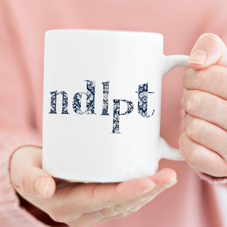 May include: White ceramic mug with a blue and white floral pattern spelling out the word "ndlpft".